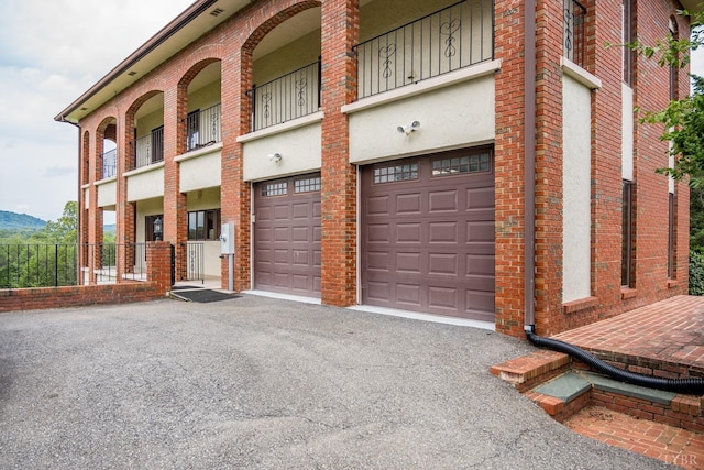 view of property featuring driveway and a garage