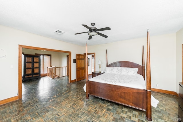bedroom featuring multiple windows, baseboards, ceiling fan, and visible vents