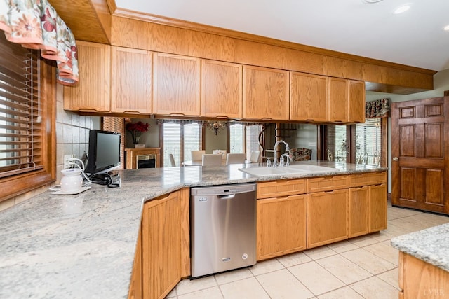 kitchen with light tile patterned flooring, a sink, plenty of natural light, and dishwasher