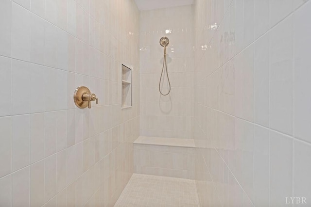 full bath featuring a tile shower