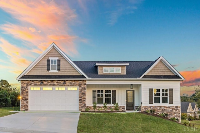 craftsman house with roof with shingles, stone siding, concrete driveway, a front lawn, and a standing seam roof