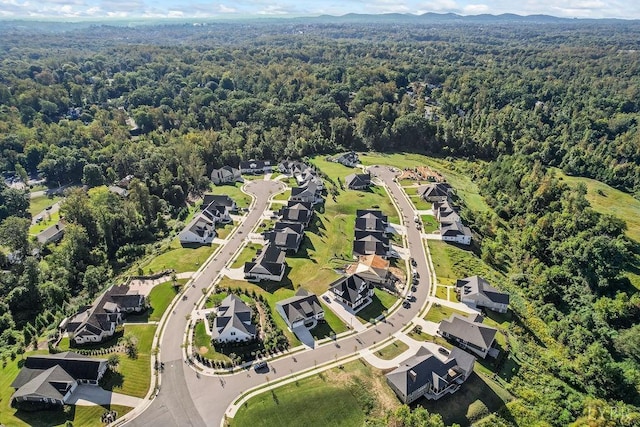 birds eye view of property featuring a wooded view