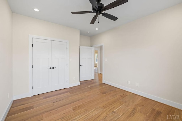 unfurnished bedroom featuring a ceiling fan, a closet, light wood-type flooring, baseboards, and recessed lighting