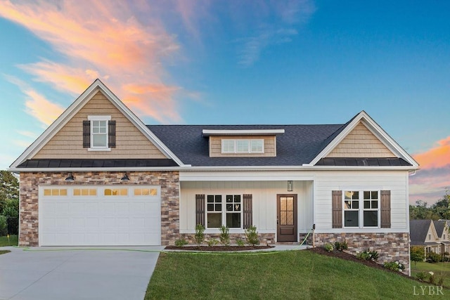 craftsman house with roof with shingles, stone siding, concrete driveway, a lawn, and a standing seam roof