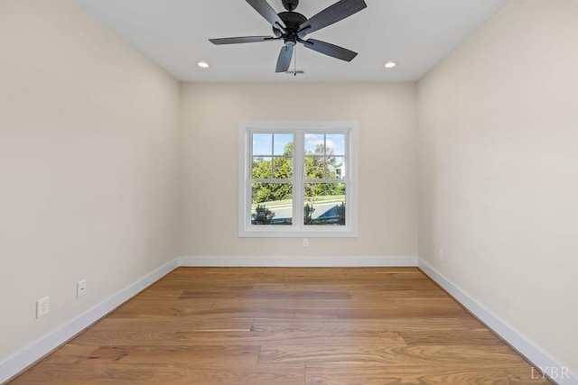 spare room featuring baseboards, recessed lighting, and wood finished floors