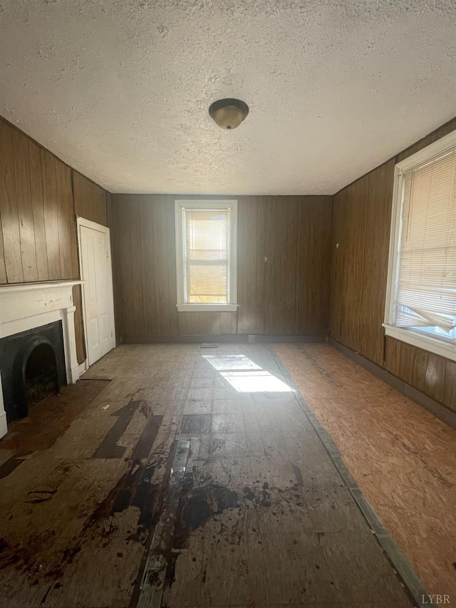 500 Amherst St, Lynchburg, VA 24504 - unfurnished living room with wooden walls, a textured ceiling, and a fireplace