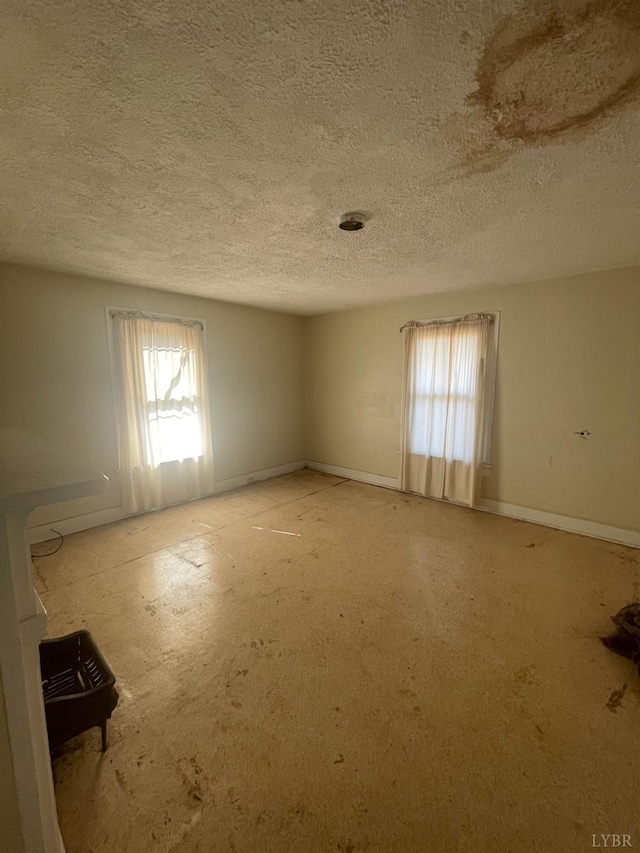 500 Amherst St, Lynchburg, VA 24504 - unfurnished room featuring plenty of natural light, a textured ceiling, and baseboards