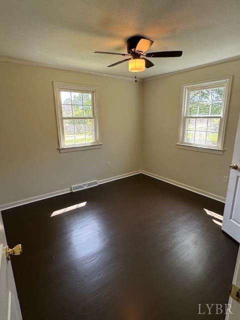 305 Eldon Rd, Appomattox, VA 24522 - empty room with visible vents, plenty of natural light, and dark wood-style flooring