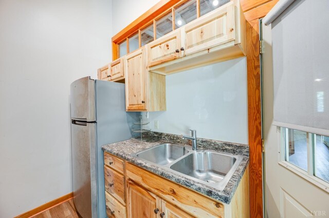 1343 Wares Gap Rd, Monroe, VA 24574 - kitchen featuring baseboards, dark countertops, a sink, light brown cabinetry, and freestanding refrigerator
