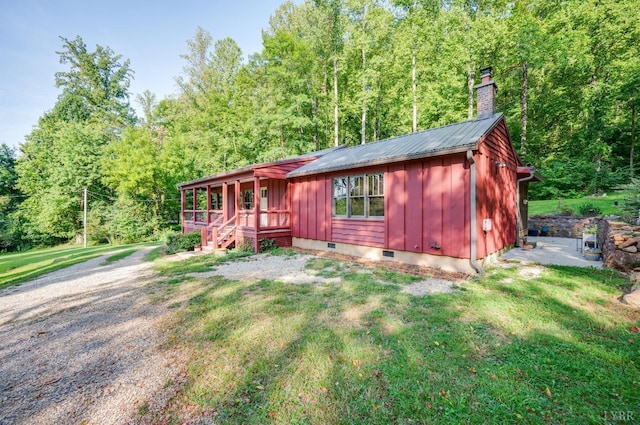 1343 Wares Gap Rd, Monroe, VA 24574 - rustic home featuring board and batten siding, a forest view, crawl space, a front lawn, and a chimney