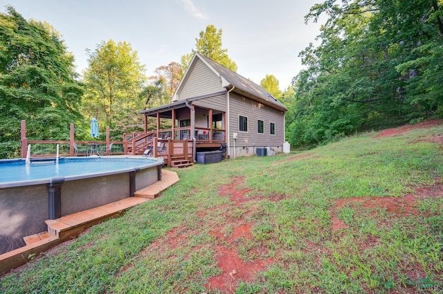 1343 Wares Gap Rd, Monroe, VA 24574 - back of property featuring a lawn, central air condition unit, a deck, and an outdoor pool