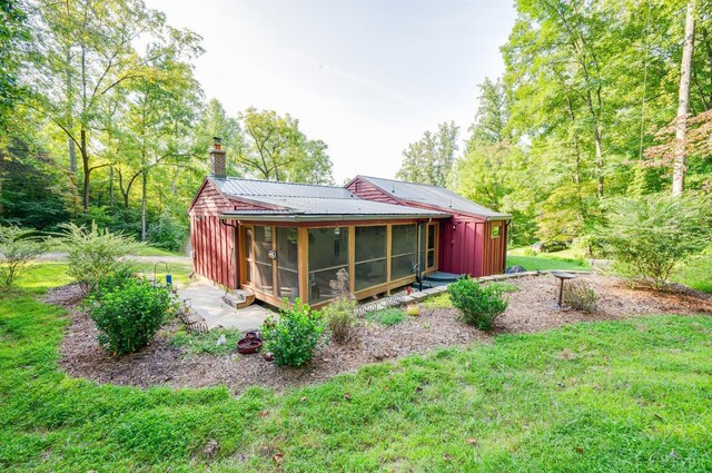 1343 Wares Gap Rd, Monroe, VA 24574 - rear view of property featuring a sunroom, metal roof, a chimney, board and batten siding, and a yard