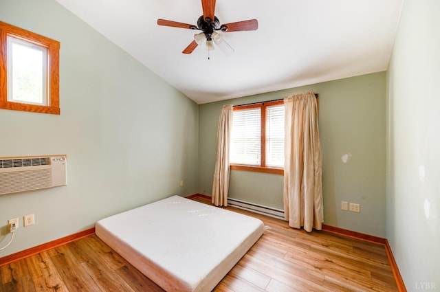 1343 Wares Gap Rd, Monroe, VA 24574 - bedroom with lofted ceiling, a baseboard heating unit, baseboards, light wood-style flooring, and a wall mounted air conditioner