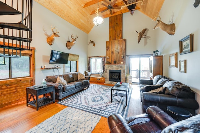 1343 Wares Gap Rd, Monroe, VA 24574 - living area featuring wooden ceiling, beam ceiling, wood finished floors, a stone fireplace, and ceiling fan