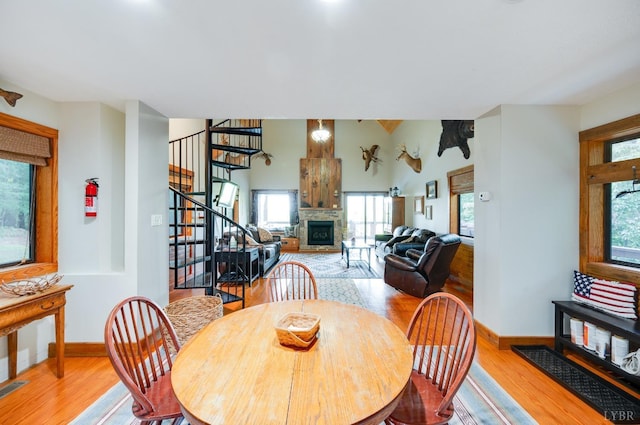 1343 Wares Gap Rd, Monroe, VA 24574 - dining space with baseboards, a fireplace, wood finished floors, and stairway