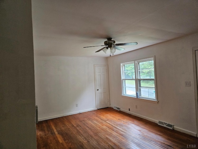 spare room with a ceiling fan, baseboards, visible vents, and wood finished floors