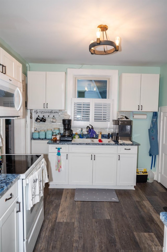 811 Broad St, Altavista, VA 24517 - kitchen with white appliances, dark hardwood / wood-style flooring, sink, and white cabinets