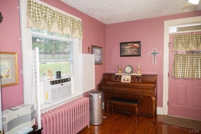 811 Broad St, Altavista, VA 24517 - sitting room featuring a textured ceiling, cooling unit, radiator, ceiling fan, and dark hardwood / wood-style floors