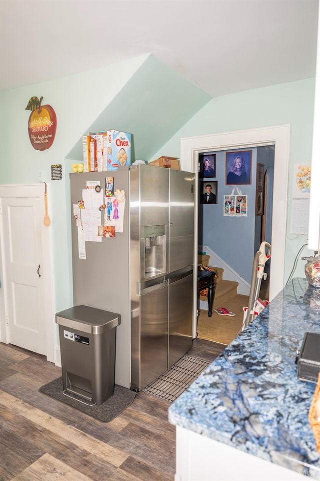811 Broad St, Altavista, VA 24517 - kitchen with stone counters, stainless steel fridge, vaulted ceiling, and dark hardwood / wood-style flooring