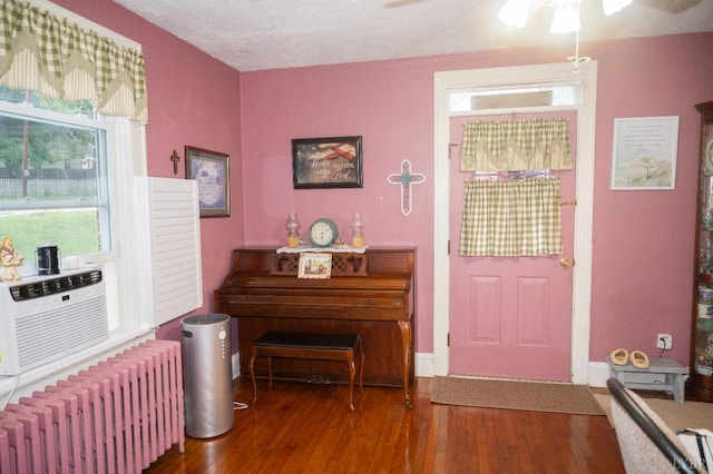 811 Broad St, Altavista, VA 24517 - entrance foyer featuring a textured ceiling, cooling unit, radiator, ceiling fan, and dark hardwood / wood-style floors