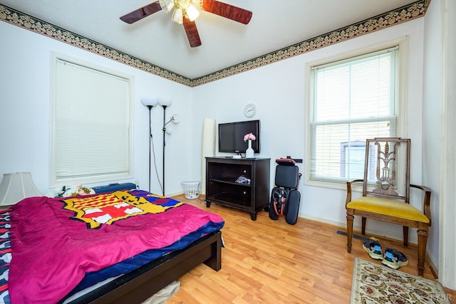906 8th St, Lynchburg, VA 24504 - bedroom featuring multiple windows, light wood finished floors, baseboards, and a ceiling fan