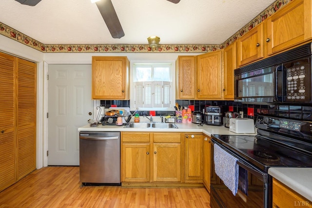 906 8th St, Lynchburg, VA 24504 - kitchen featuring black appliances, a sink, light countertops, and light wood finished floors