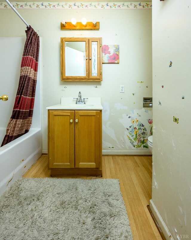 906 8th St, Lynchburg, VA 24504 - bathroom with wood finished floors, toilet, vanity, and baseboards