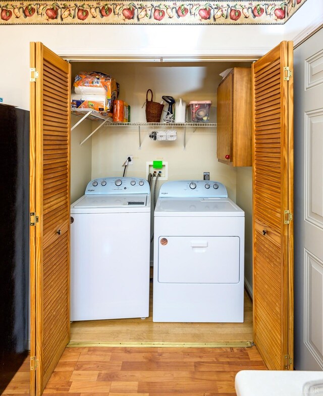 906 8th St, Lynchburg, VA 24504 - laundry room featuring washing machine and clothes dryer, cabinet space, and light wood finished floors