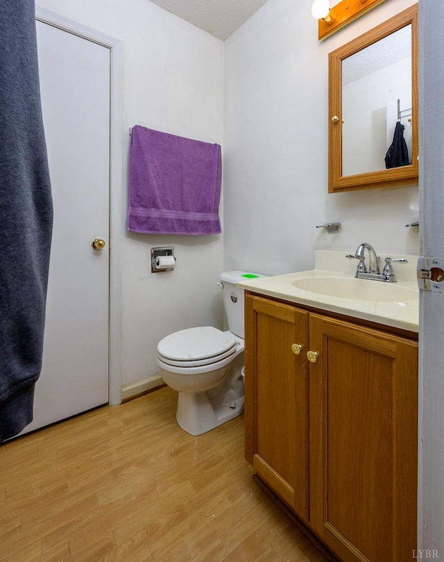 906 8th St, Lynchburg, VA 24504 - half bathroom featuring wood finished floors, toilet, and vanity