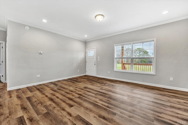 unfurnished living room with crown molding, baseboards, and wood finished floors