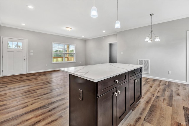 1095 Fox Ln, Moneta, VA 24121 - kitchen with ornamental molding, light wood-type flooring, pendant lighting, baseboards, and dark brown cabinets
