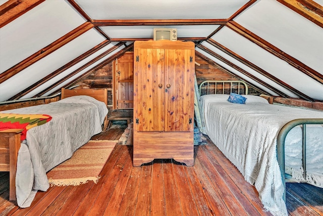bedroom featuring lofted ceiling and dark hardwood / wood-style flooring