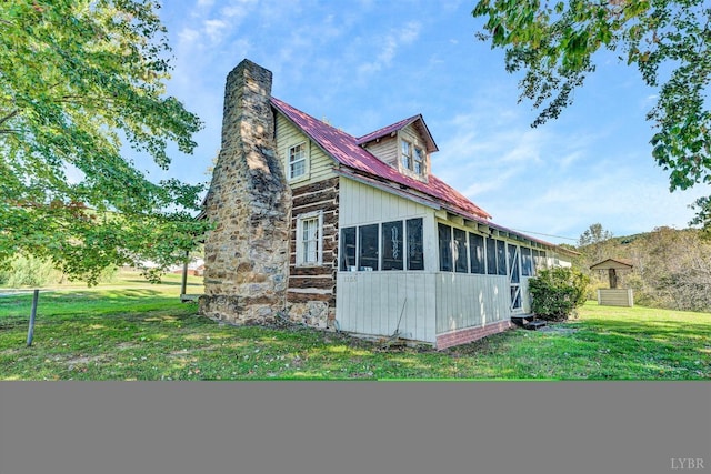 1155 Gaston Rd, Vinton, VA 24179 - view of side of home with a sunroom, a chimney, and a lawn
