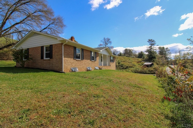 5427 Snake Creek Rd, Stuart, VA 24343 - view of side of home with a chimney, a yard, and brick siding