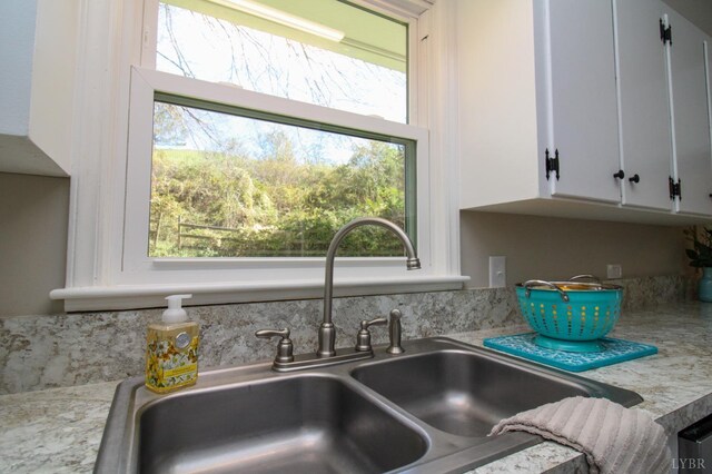 5427 Snake Creek Rd, Stuart, VA 24343 - interior details featuring a sink, white cabinets, and light countertops