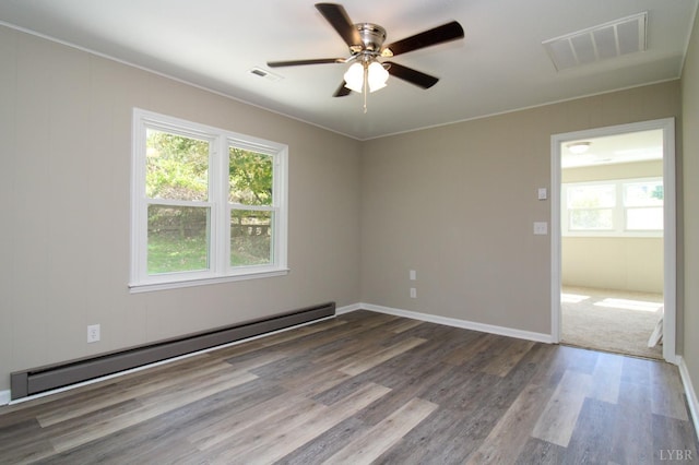 5427 Snake Creek Rd, Stuart, VA 24343 - spare room featuring a ceiling fan, visible vents, wood finished floors, and a baseboard radiator