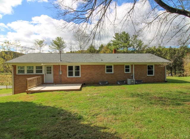 5427 Snake Creek Rd, Stuart, VA 24343 - back of property featuring a lawn, a wooden deck, central AC unit, and brick siding