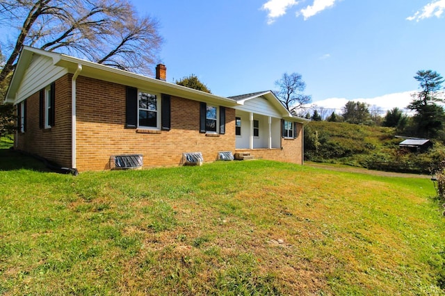 5427 Snake Creek Rd, Stuart, VA 24343 - view of front facade with a chimney, brick siding, and a front lawn