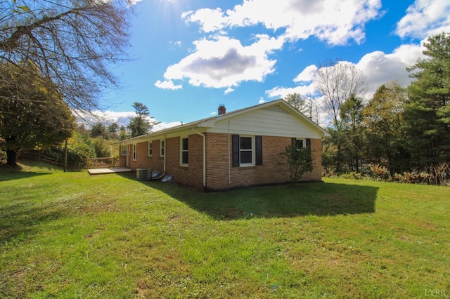 5427 Snake Creek Rd, Stuart, VA 24343 - view of property exterior featuring a chimney, brick siding, central AC unit, and a lawn