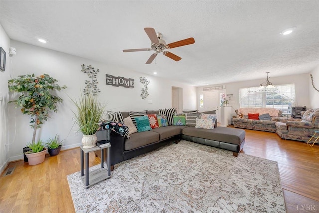 1746 Fiddler Creek Rd, Bedford, VA 24523 - living room with ceiling fan with notable chandelier, hardwood / wood-style floors, and a textured ceiling