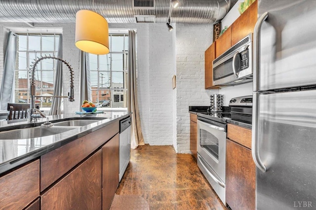 400 SW Salem Ave Unit 2B, Roanoke, VA 24016 - kitchen with concrete floors, stainless steel appliances, dark stone countertops, a sink, and brick wall