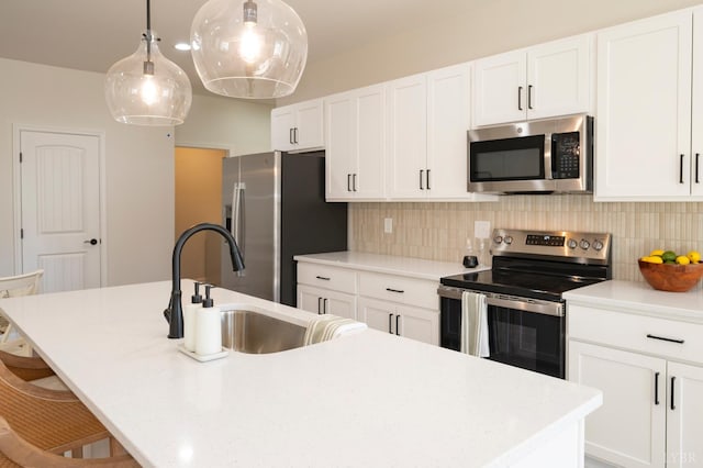 128 Brenleigh Ct Unit 306, Lynchburg, VA 24501 - kitchen with appliances with stainless steel finishes, an island with sink, a sink, and white cabinetry