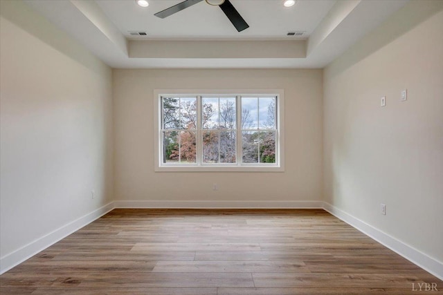 1161 Golf View Ct, Huddleston, VA 24104 - empty room with a raised ceiling, ceiling fan, wood finished floors, recessed lighting, and baseboards