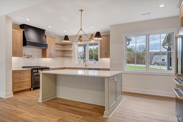 1161 Golf View Ct, Huddleston, VA 24104 - kitchen with custom exhaust hood, high end stainless steel range oven, light countertops, light wood finished floors, and recessed lighting
