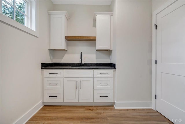 1161 Golf View Ct, Huddleston, VA 24104 - kitchen with a sink, baseboards, white cabinetry, and light wood-style floors
