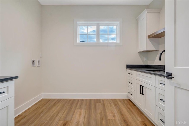 1161 Golf View Ct, Huddleston, VA 24104 - laundry room with light wood-style flooring, baseboards, and cabinet space