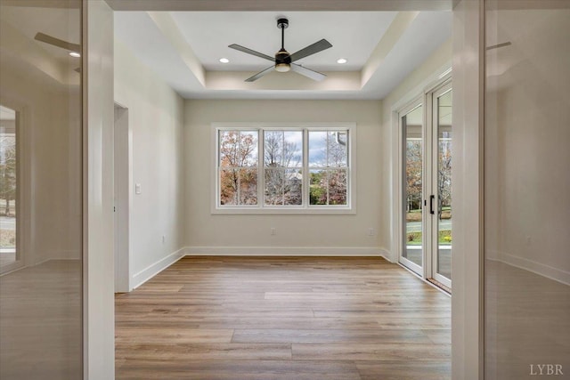 1161 Golf View Ct, Huddleston, VA 24104 - unfurnished room with a tray ceiling, wood finished floors, a ceiling fan, baseboards, and recessed lighting
