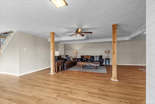 2180 Lime Plant Rd, Appomattox, VA 24522 - living room with light wood finished floors, ceiling fan, stairway, baseboards, and a textured ceiling