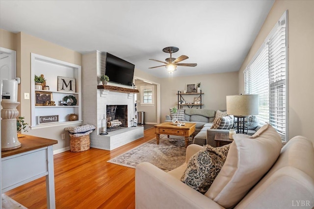 2180 Lime Plant Rd, Appomattox, VA 24522 - living room with a ceiling fan, a brick fireplace, wood finished floors, and baseboards