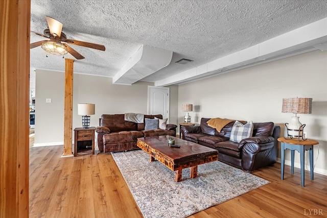 2180 Lime Plant Rd, Appomattox, VA 24522 - living area featuring a textured ceiling, light wood finished floors, a ceiling fan, and baseboards